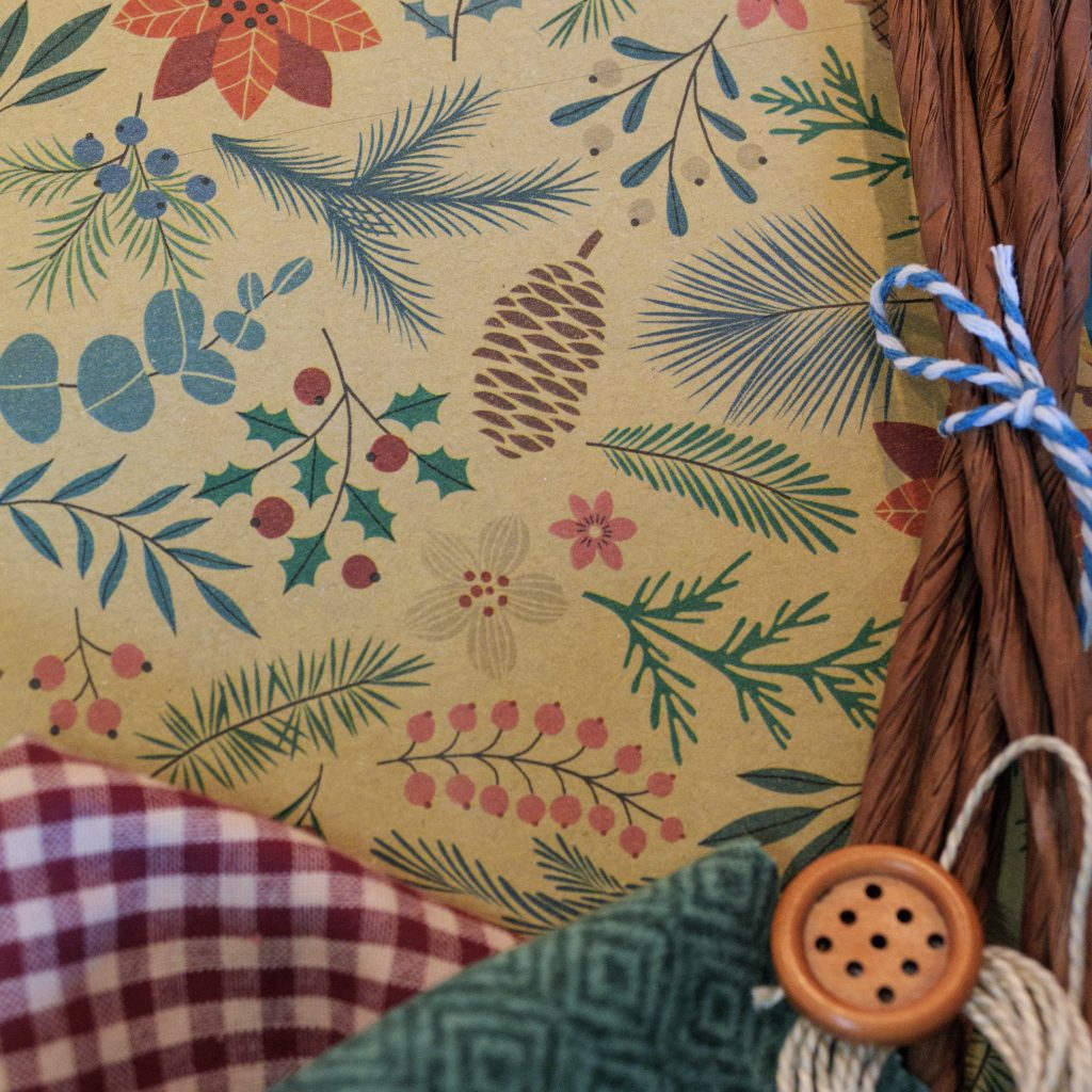 DIY fabric-and-paper craft kit materials with Holiday Botanicals paper featuring seasonal foliage, fabrics, raffia, button and string