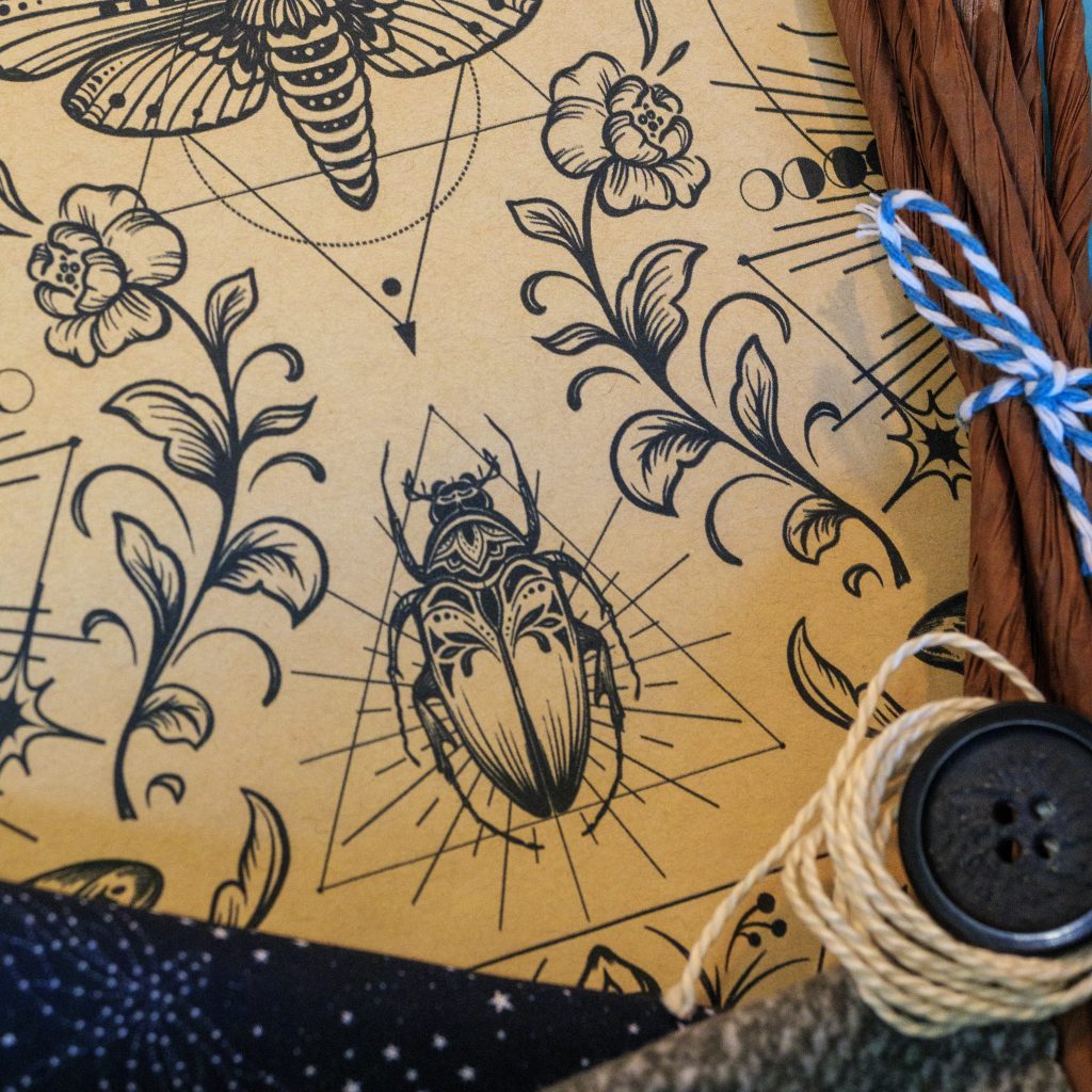 DIY fabric-and-paper craft kit materials with Science Magic paper featuring vintage science-inspired imagery, fabrics, raffia, button and string