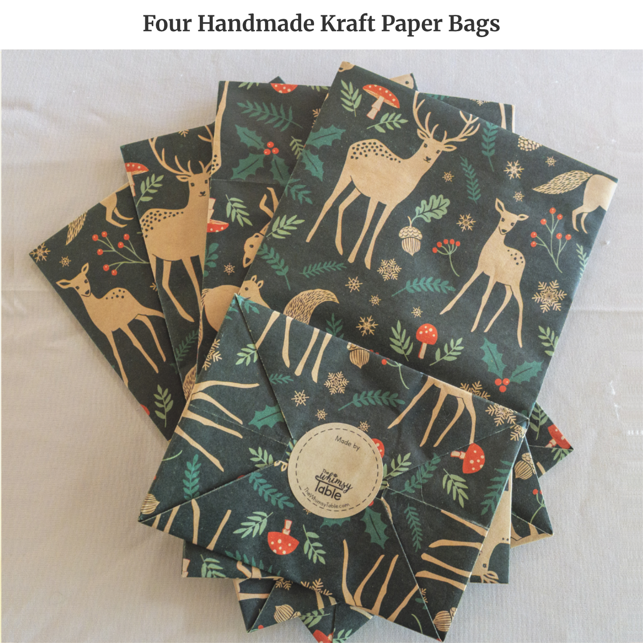 Four handmade kraft gift bags made from Woodland Creatures paper featuring forest animals and foliage